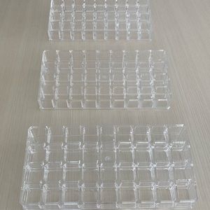 5 clear acrylic lipstick holders for makeup organization.
